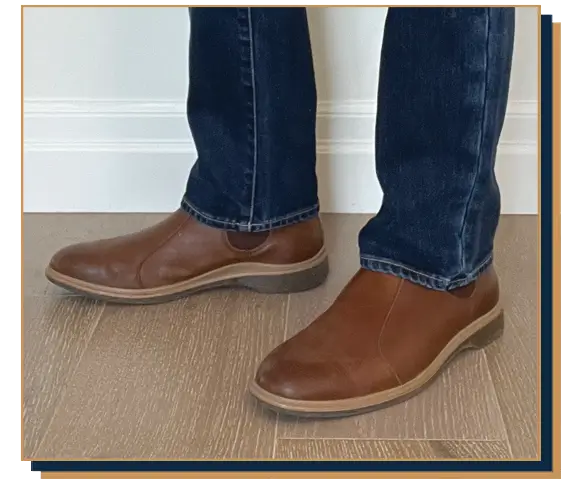 Dave Bowden wearing blue jeans and brown leather Chelsea boots from Amberjack
