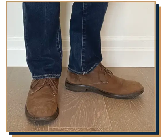 Dave Bowden wearing blue jeans and brown chukka boots