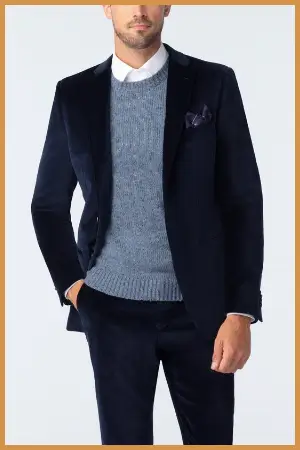 Man wearing a crew neck sweater under a suit jacket