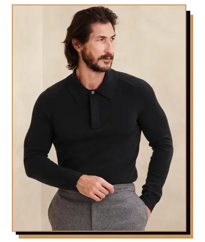 Man wearing black polo sweater and grey pants