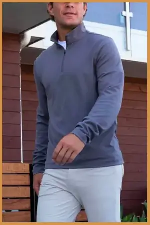 Man wearing a light blue quarter-zip sweater and joggers