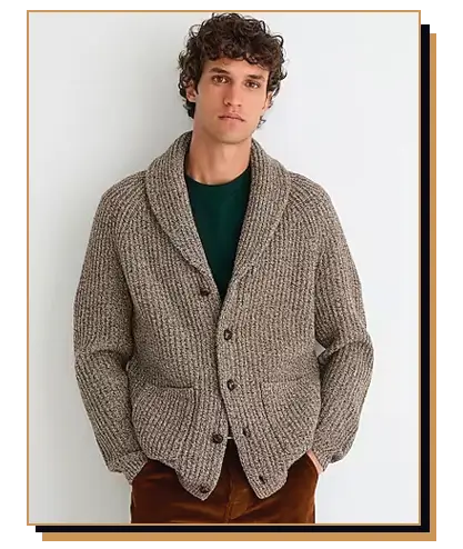 Man wearing a beige shawl collar cardigan and brown pants