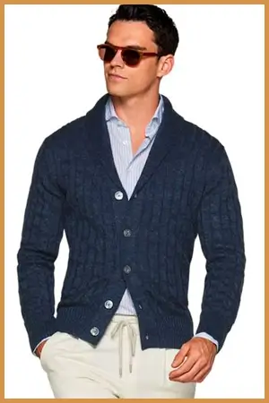 Man wearing a blue shawl collar cardigan over top of a dress shirt