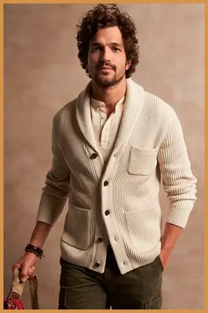 Man wearing a cream-color shawl collar cardigan over a henley 