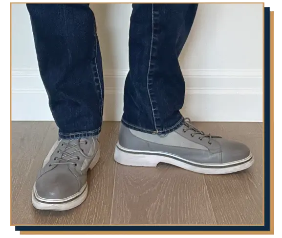 Dave Bowden wearing blue jeans and grey leather hybrid sneaker boots from Marc Nolan