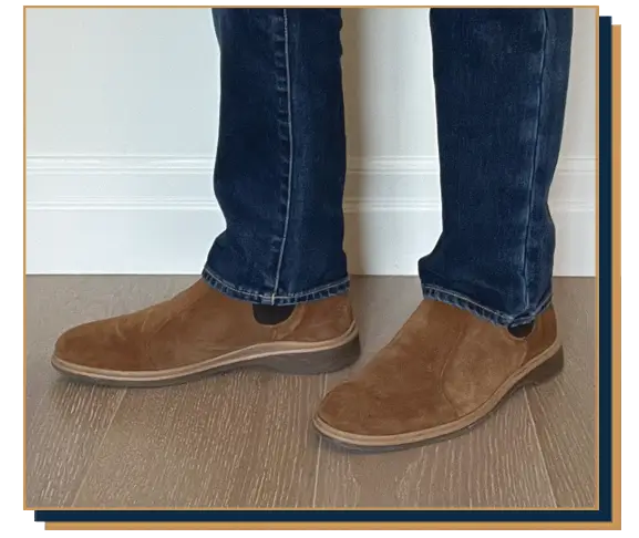 Dave Bowden wearing blue jeans and light brown suede Chelsea boots from Amberjack