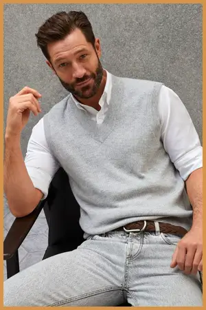 Man wearing grey sweater vest