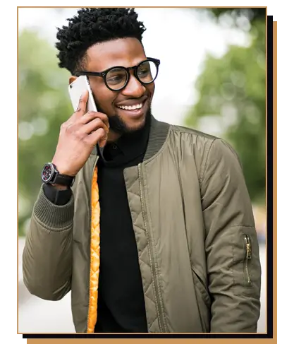 Man wearing a green bomber and black turtle neck while talking on phone 