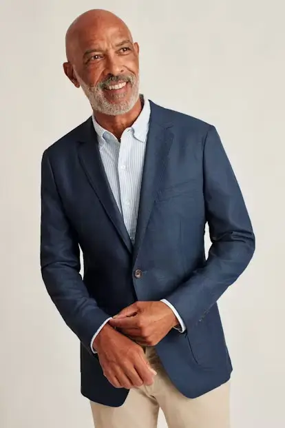 Man wearing blue blazer and khaki pants