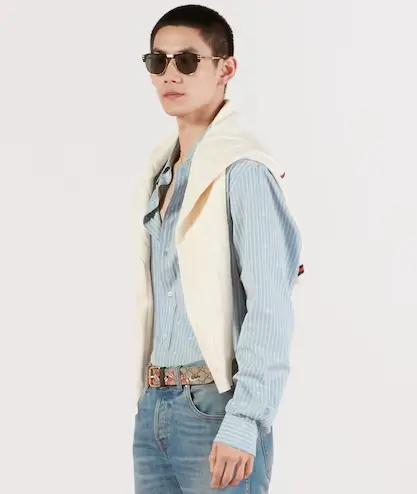 Man wearing blue Gucci shirt with sweater over shoulders