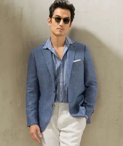 Man wearing blue blazer and white pants