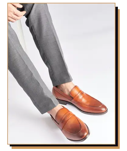Man wearing brown penny loafers and dress pants