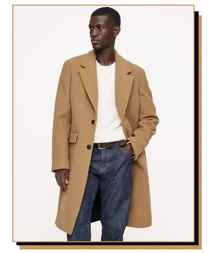 Man wearing a camel overcoat with blue jeans
