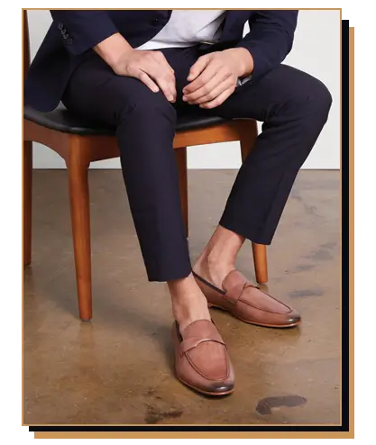 Man wearing blue suit and brown leather loafers