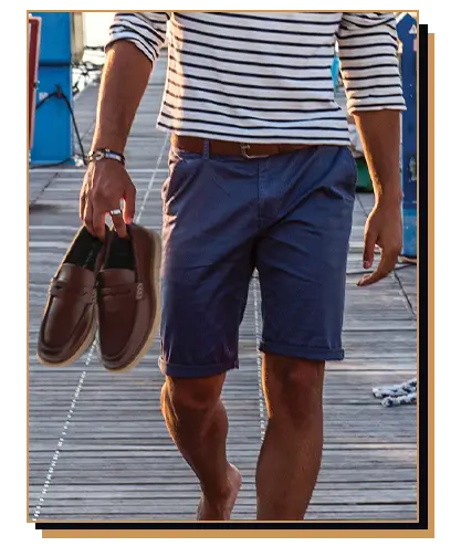 Man carrying loafers on a dock