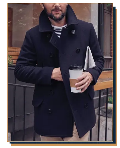 A classic navy blue mens peacoat styled with khakis and a t-shirt