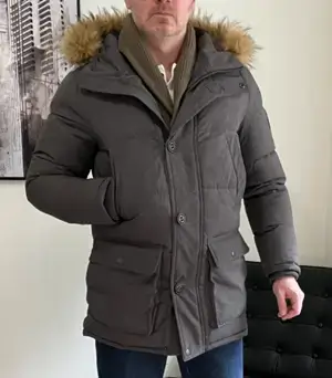 Irreverent Gent founder Dave Bowden wearing a gray parka with green shawl collar sweater
