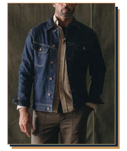 A handsome man wearing a blue denim jacket from Taylor Stitch
