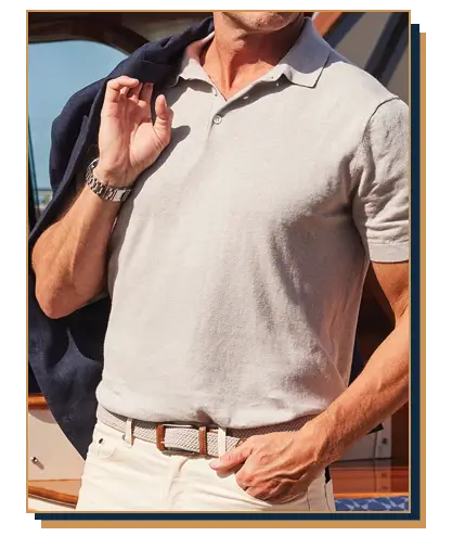 Man wearing a light gray polo with gray woven belt and white pants