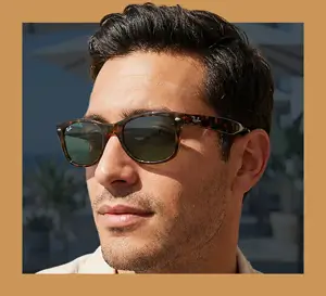 Ray-Ban-New-Wayfarers Close-up portrait of a man wearing Ray-Ban tortoiseshell sunglasses with green lenses.